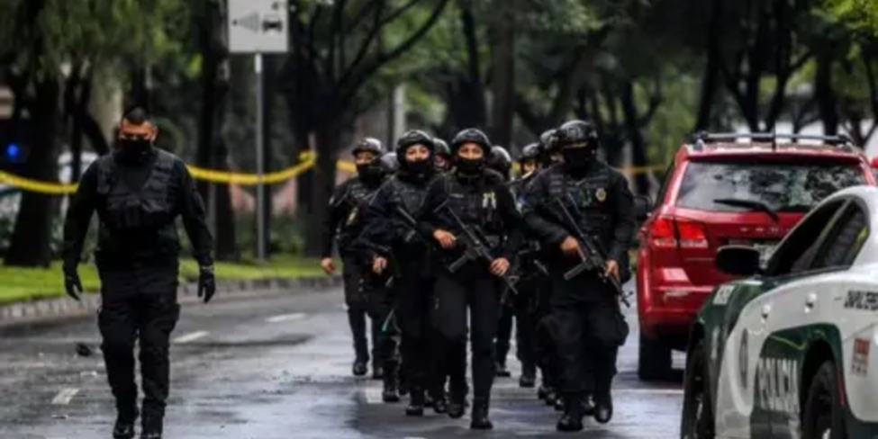 "Heavily armed police officers patrolling a crime scene in dangerous cities in Mexico."