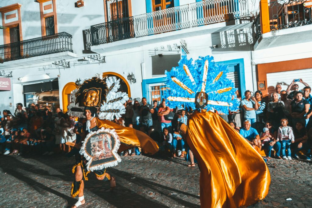 Is mexico a city safe?Vibrant street parade with colorful costumes and dancers in Puerto Vallarta, Mexico.