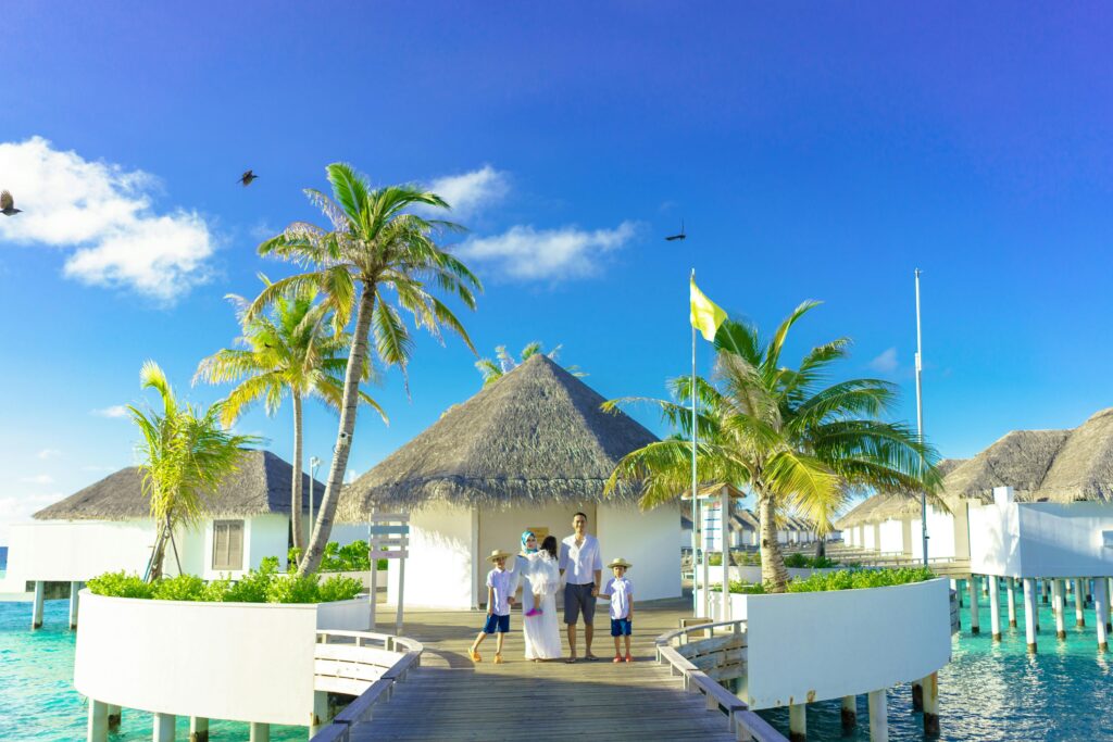 A family enjoys a sunny day at a luxurious overwater resort in a tropical paradise.