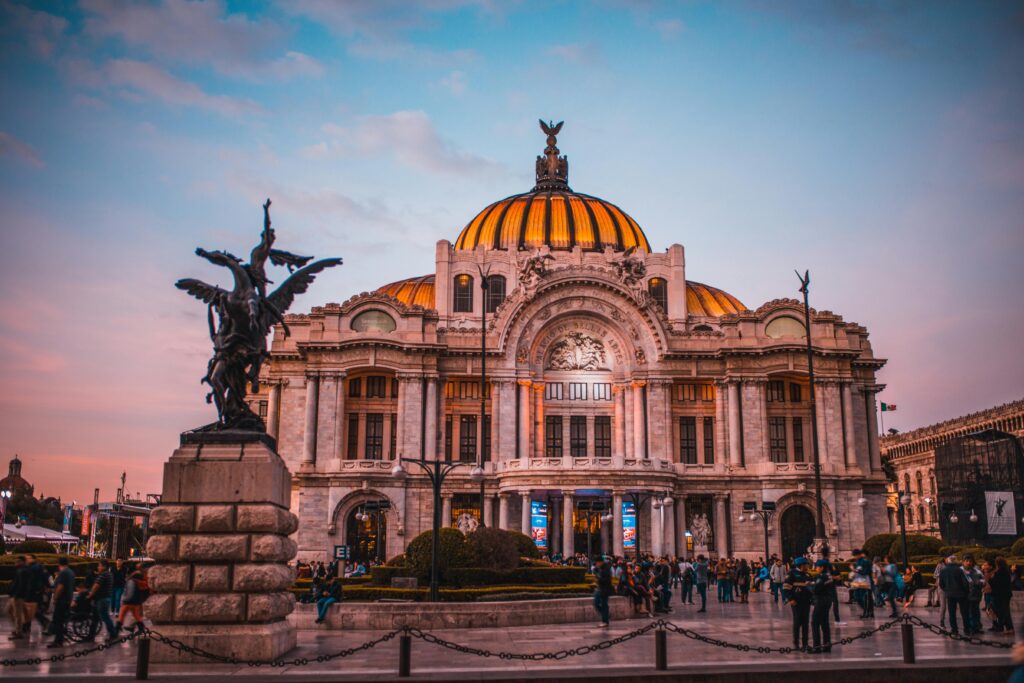 "Vibrant sunset at Palacio de Bellas Artes in Mexico City, a cultural gem in dangerous cities in Mexico."